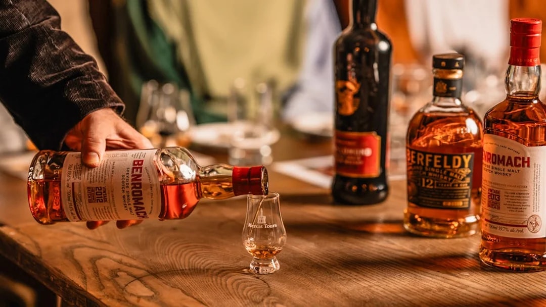Pouring whiskey into a glass at Megget's Cellar tasting event.