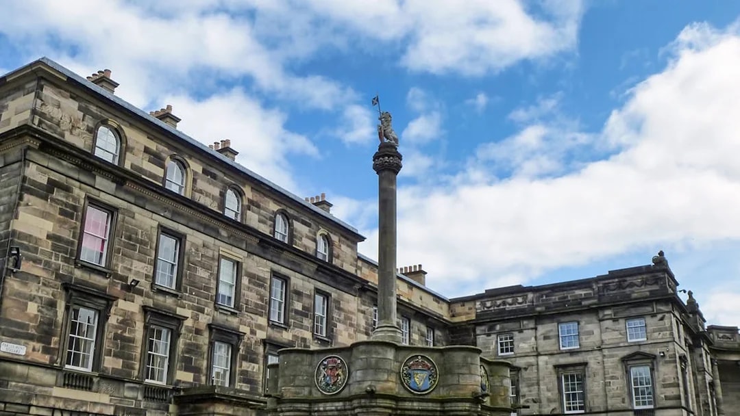 Mercat Cross with Royal Unicorn and heraldic medallions in Old Town, Edinburgh.