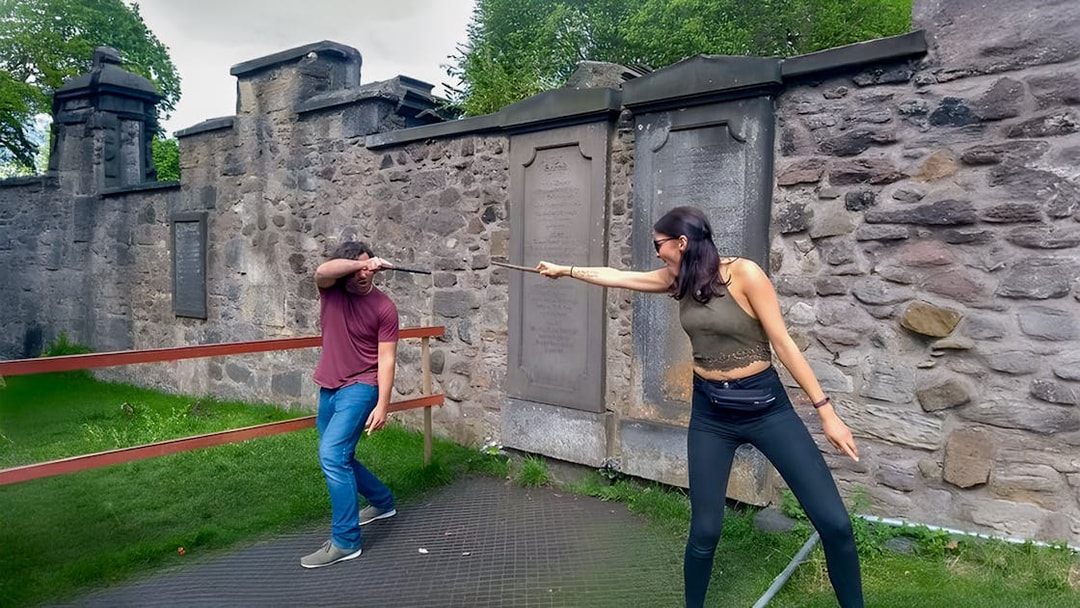 Two people reenacting a wand duel on the Harry Potter walking tour in Edinburgh.
