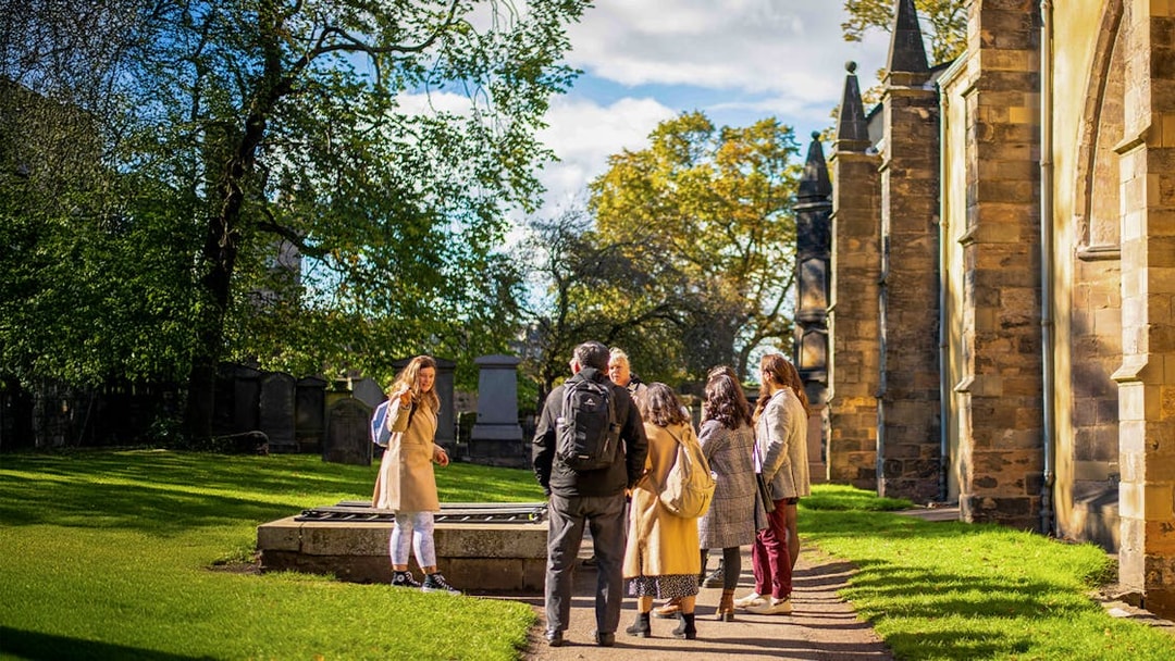 Group on a guided Harry Potter walking tour in a historic cemetery.