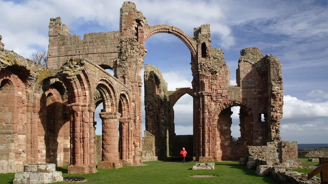 Lindisfarne Priory ruins with arches on Holy Island, England.