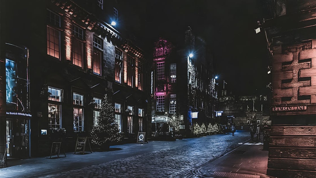 Historic street at night with illuminated buildings on the Extreme Paranormal Activity Tour.