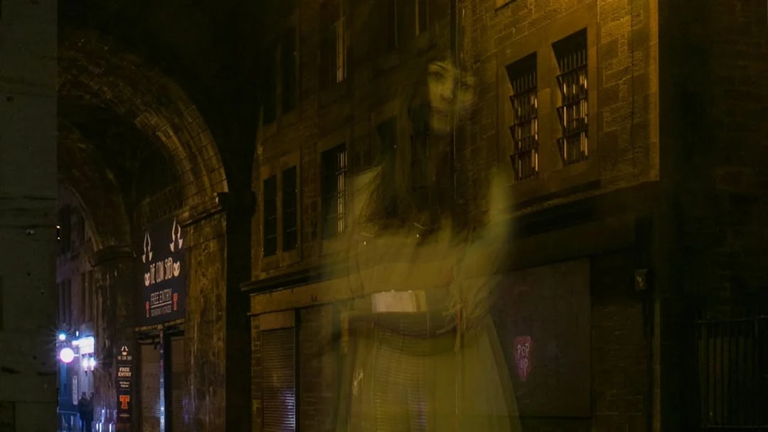 Ghostly figure in a dimly lit alley during Extreme Paranormal Activity Tour.