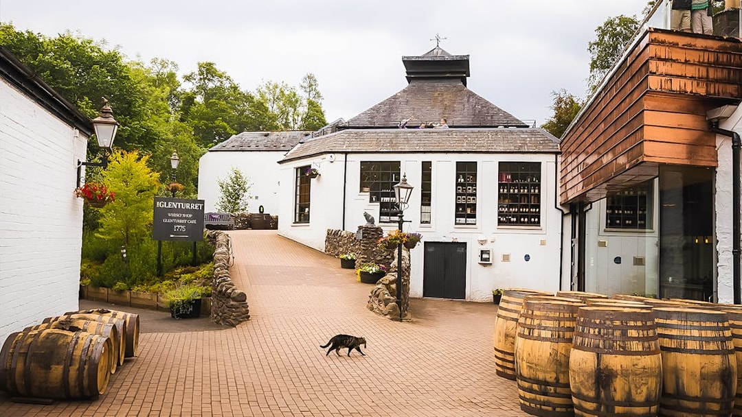 Glenturret Distillery courtyard with whisky barrels, part of Edinburgh day tour.