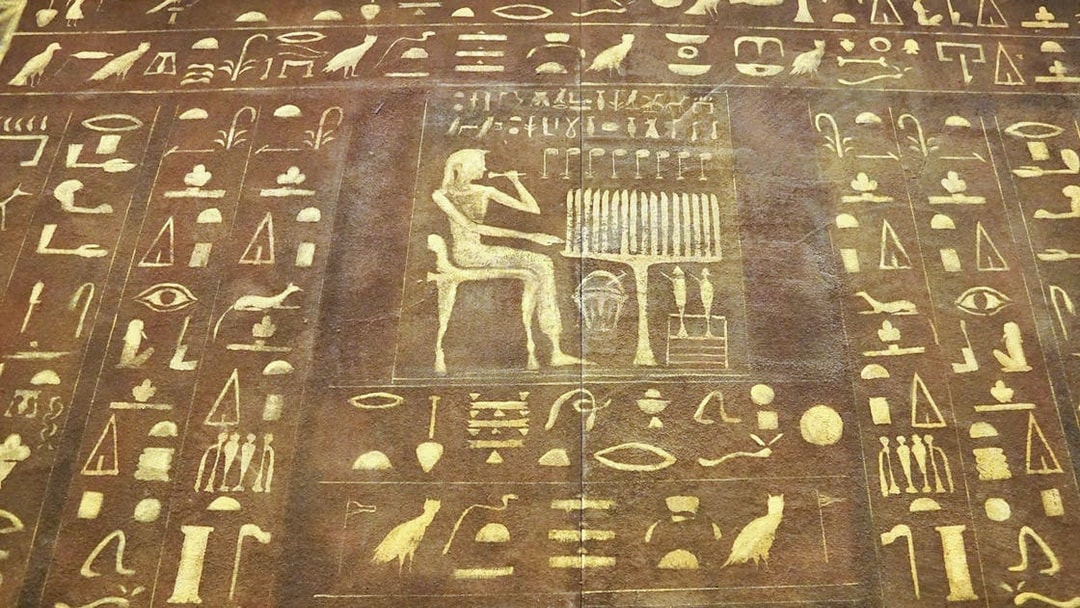 Ancient Egyptian hieroglyphs on a stone tablet at the Egyptian Museum.