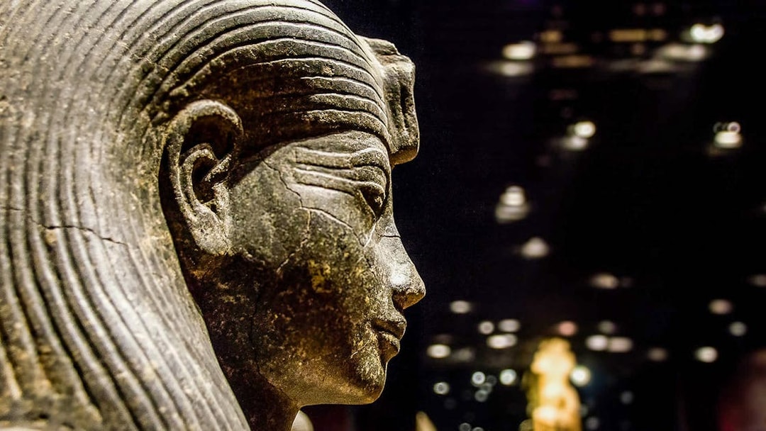 Ancient Egyptian statue in the Egyptian Museum, Cairo, during a guided tour.