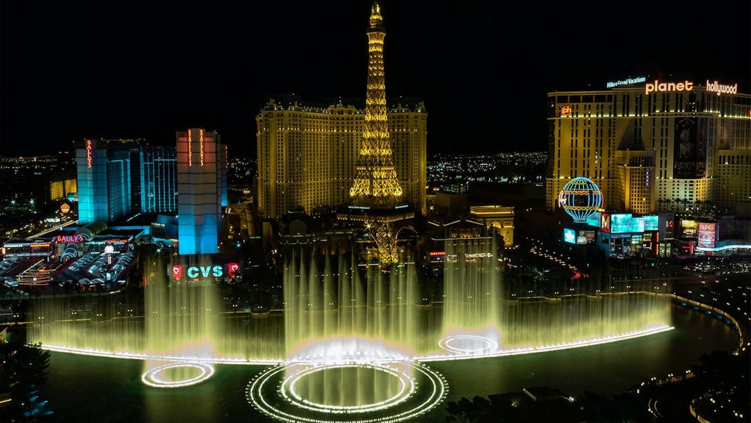 Eiffel Tower replica and Bellagio Fountains at night, Las Vegas Strip.