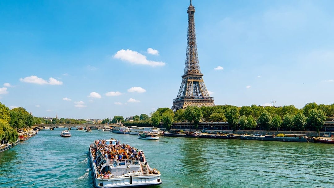 Seine River cruise boat near Eiffel Tower in Paris.