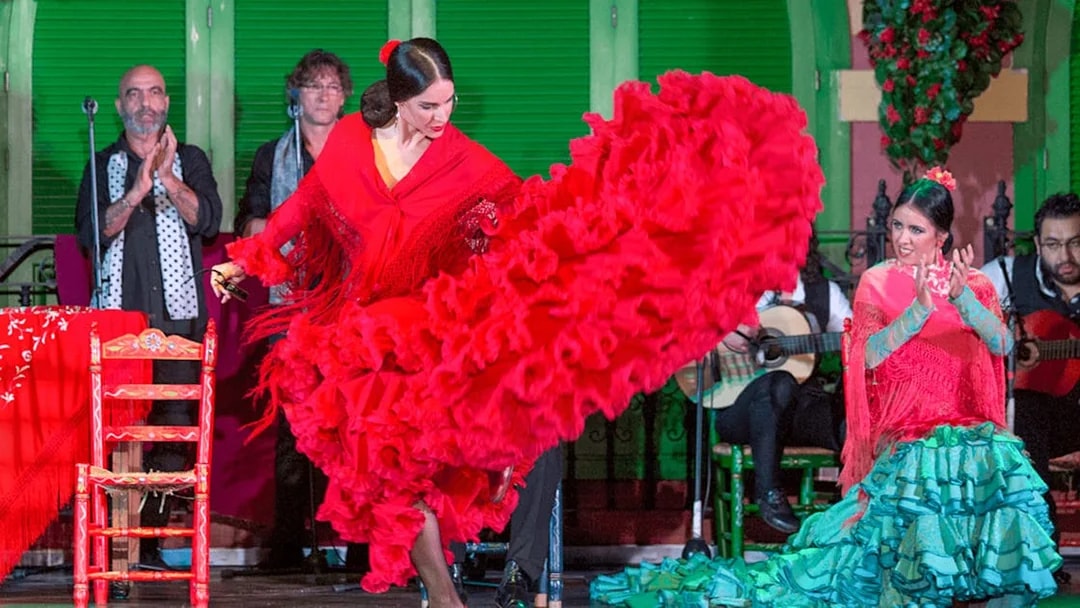 Flamenco dancer in red dress performing at Only Flamenco, Seville.