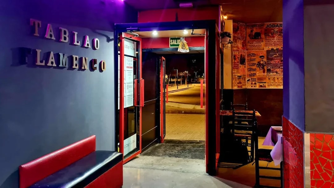 Entrance to Tablao El Toro y la Luna, showcasing flamenco posters and seating area.