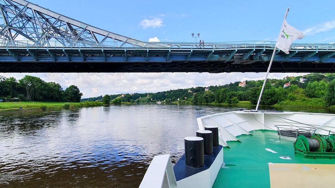 Elbe River cruise passing under Blue Wonder Bridge in Dresden.