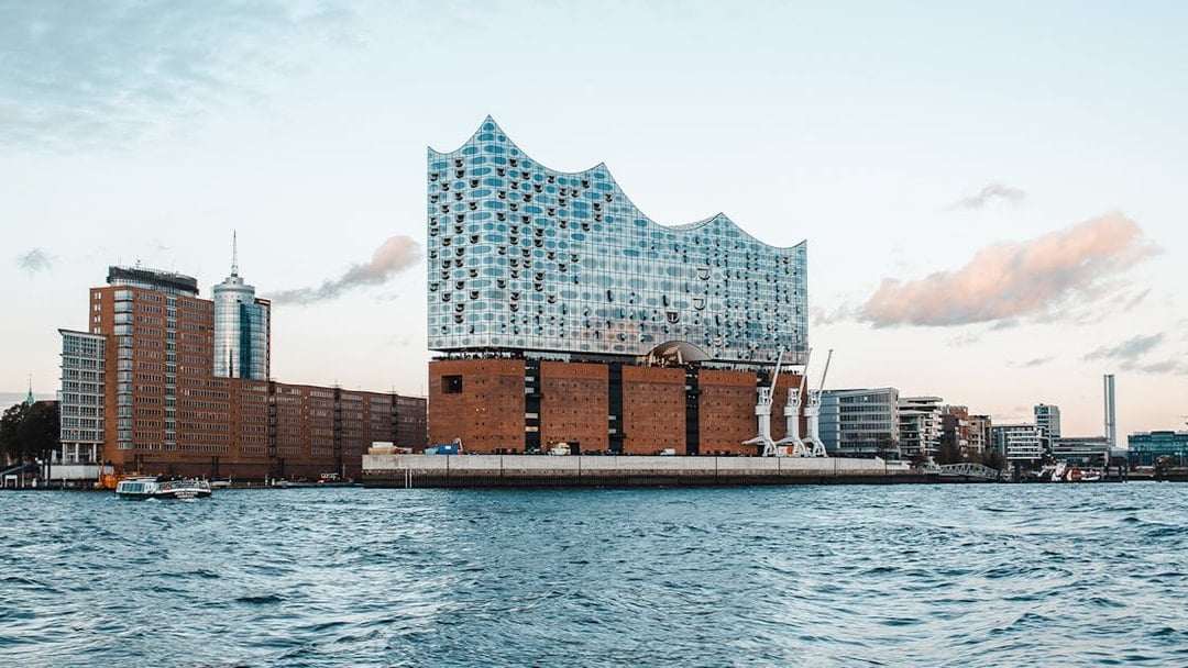 Elbphilharmonie building exterior in Hamburg, viewed from the water.
