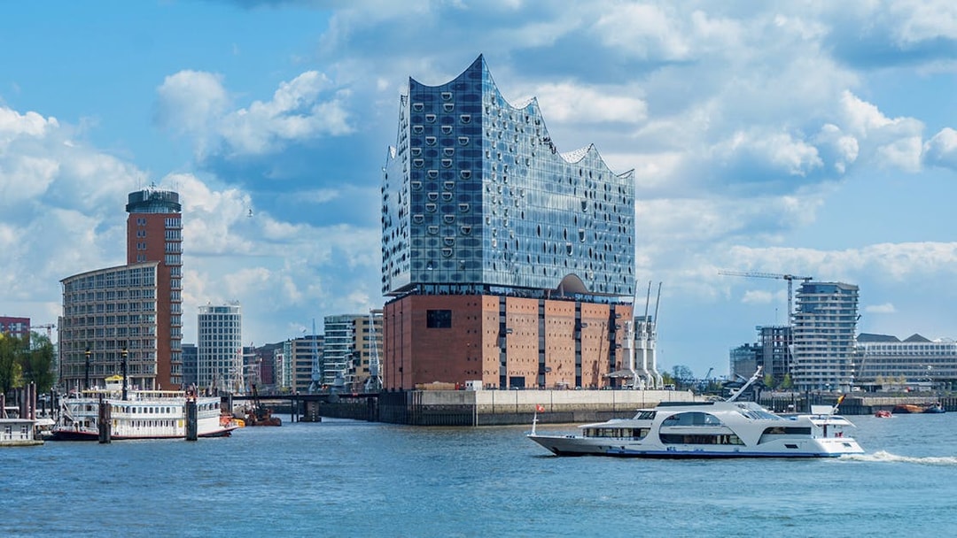 Elbphilharmonie concert hall in Hamburg with boats on the Elbe River.