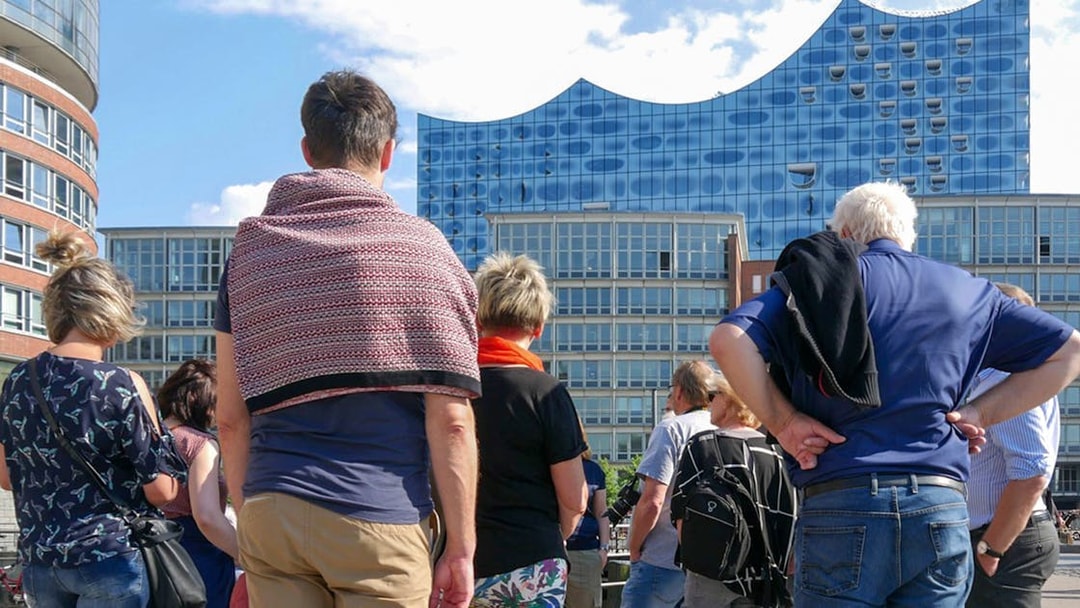 Group of tourists on a guided tour in front of the Elbphilharmonie, Hamburg.
