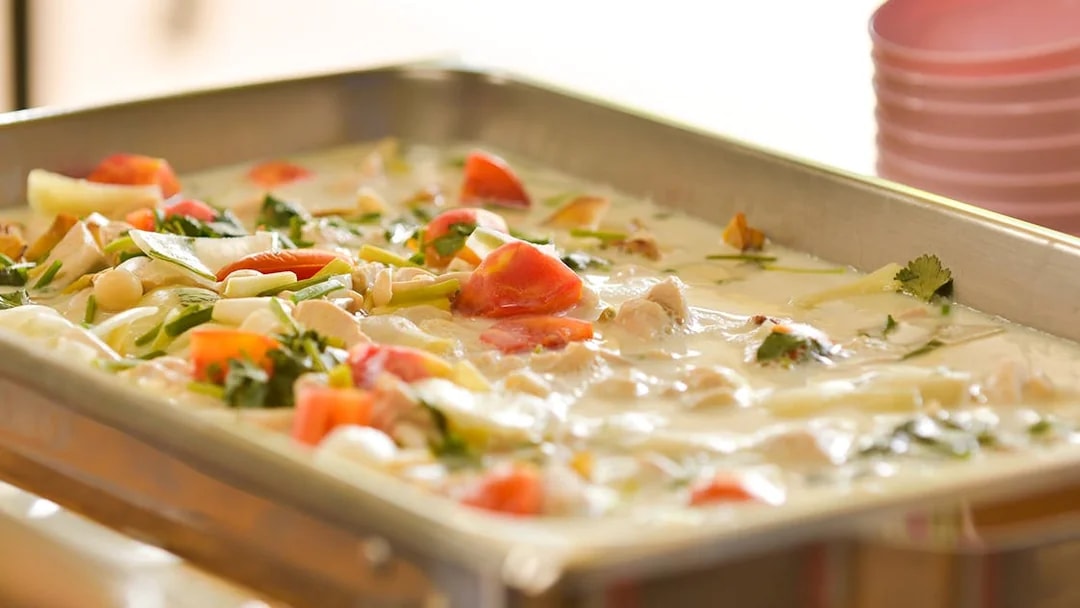 A tray of Thai coconut soup with vegetables and herbs at Elephant Jungle Sanctuary.