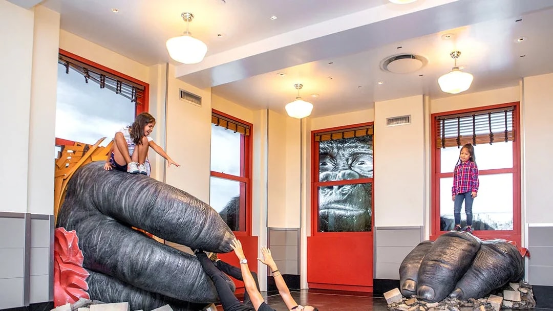Children playing on giant gorilla hands at Empire State Building Observatory, New York City.