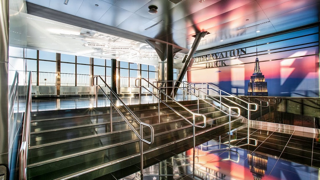 Empire State Building Observatory interior with view of New York City skyline.