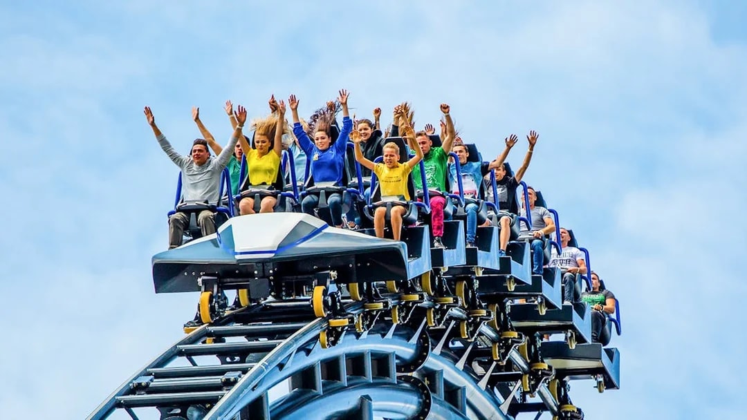 Visitors on a roller coaster at Energylandia, Poland, enjoying a thrilling ride.