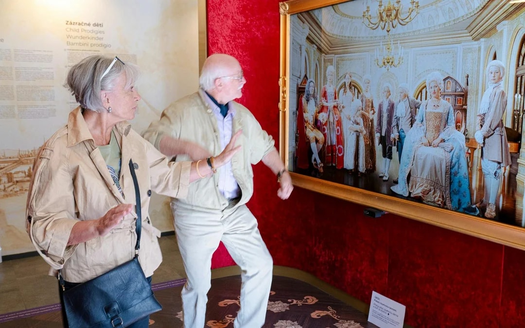 Guests interacting with a digital display at the Mozart Interactive Museum in Prague.