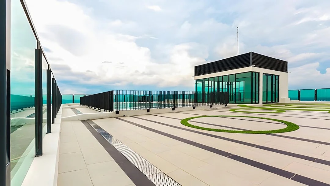 Rooftop view from The Shore Sky Tower with glass railings and modern architecture.