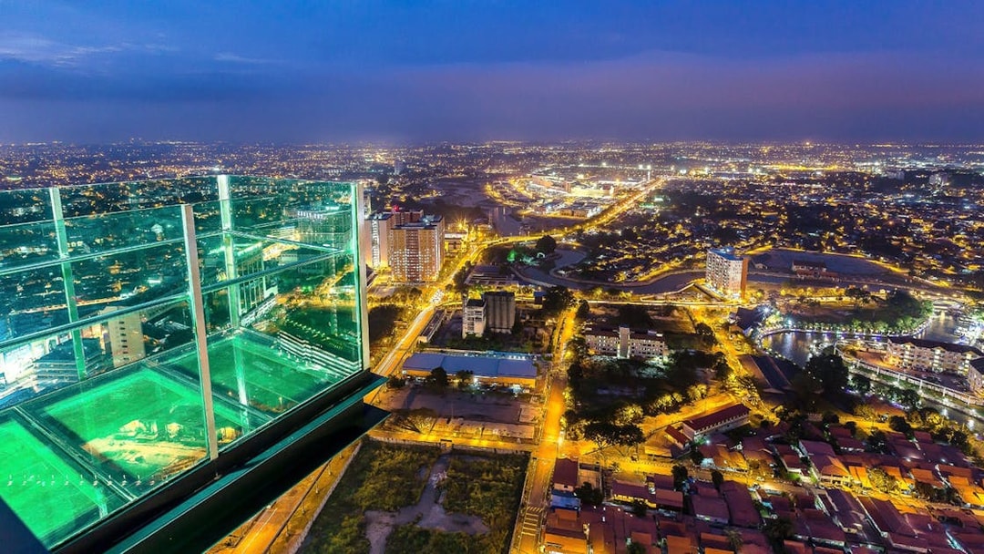View from The Shore Sky Tower overlooking city lights at night in Melaka, Malaysia.