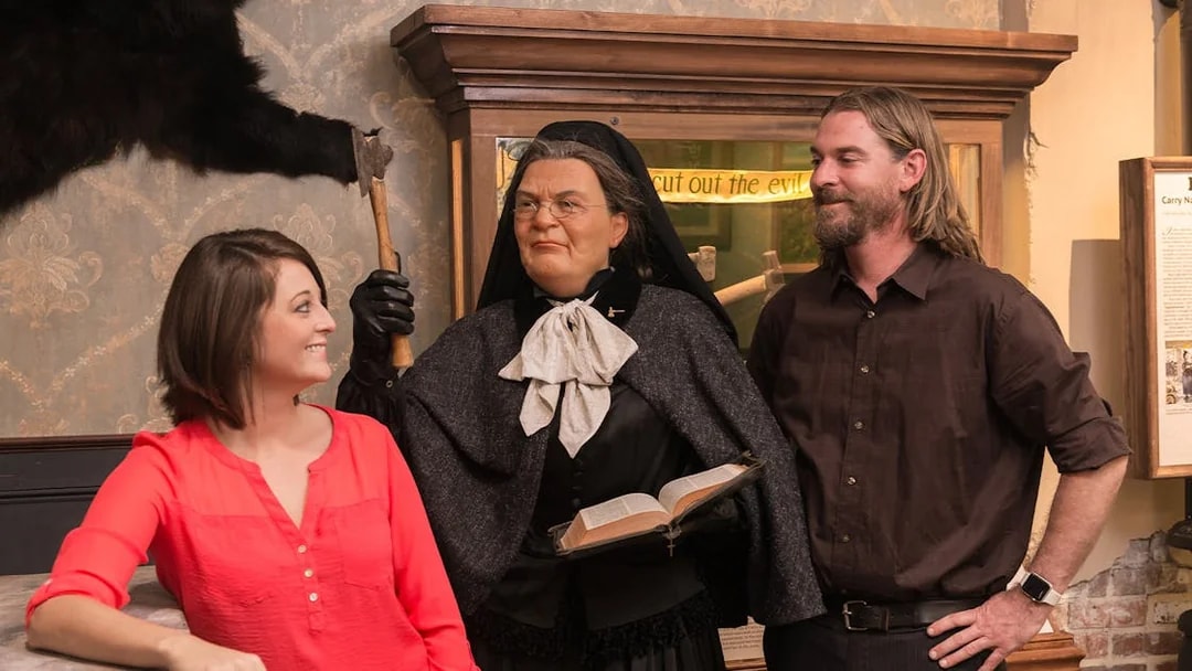 Visitors interacting with a wax figure at the American Prohibition Museum.