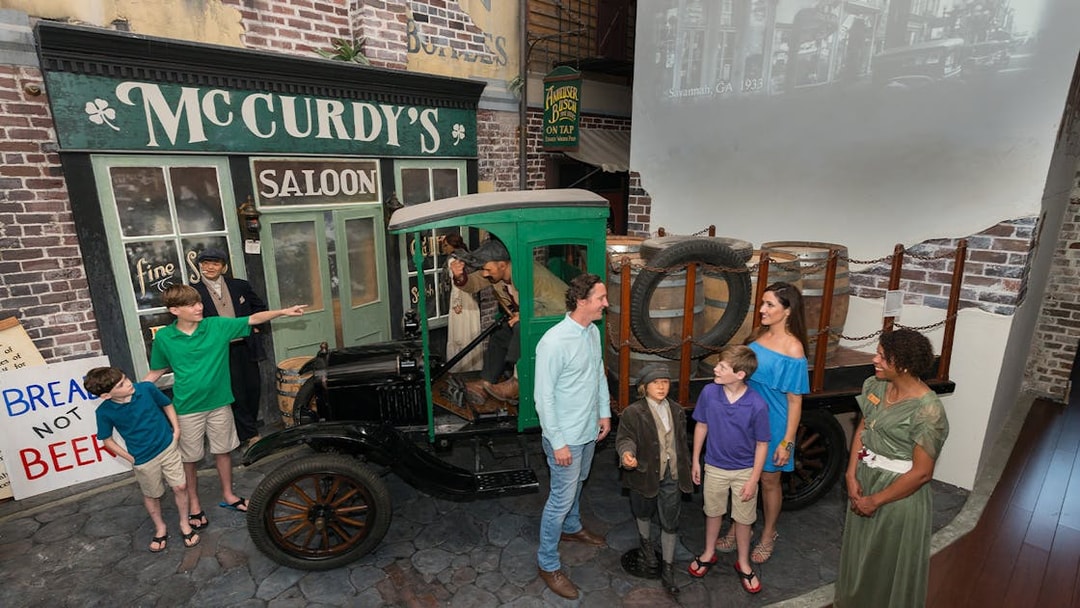 Visitors explore a vintage truck exhibit at the American Prohibition Museum in Savannah.