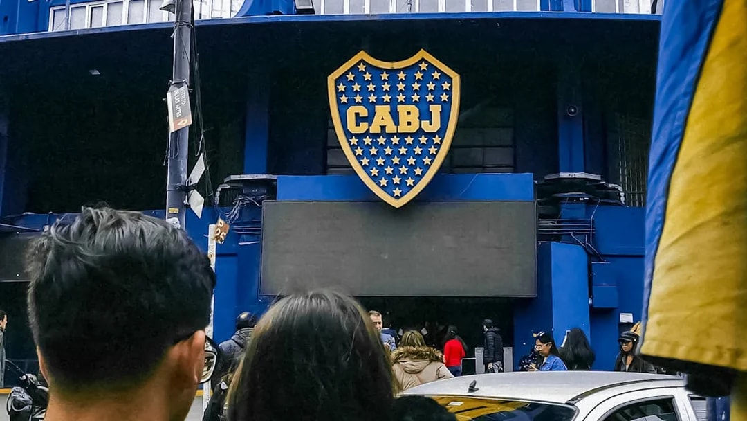 Couple outside La Bombonera stadium entrance in Buenos Aires.