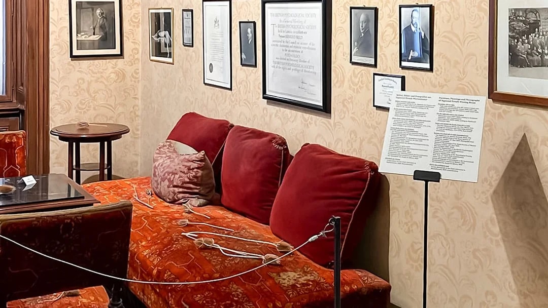 Sigmund Freud Museum interior with red couch and framed photos on the wall.