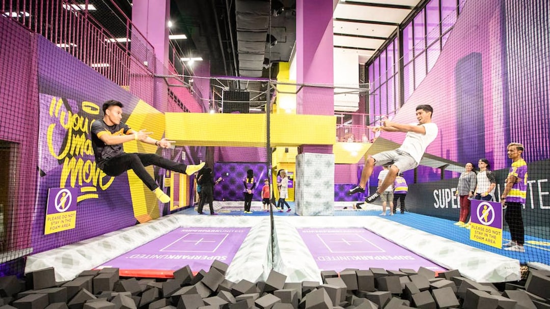 Men jumping on trampolines at SuperPark, Malaysia.