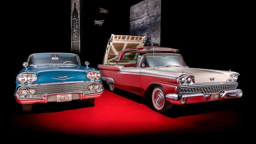 Classic cars display at Technik Museum Sinsheim with vintage license plates.