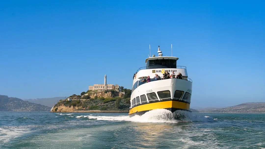 Ferry with guests sailing near Alcatraz Island, San Francisco.