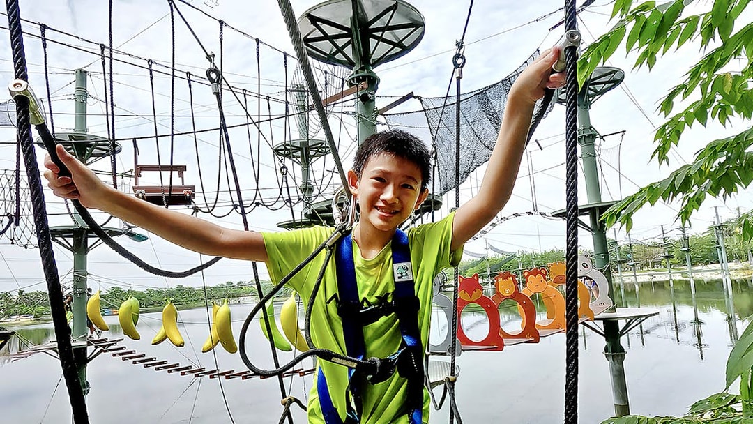 Child navigating ropes course at ESCAPE Ipoh Theme Park, Malaysia.