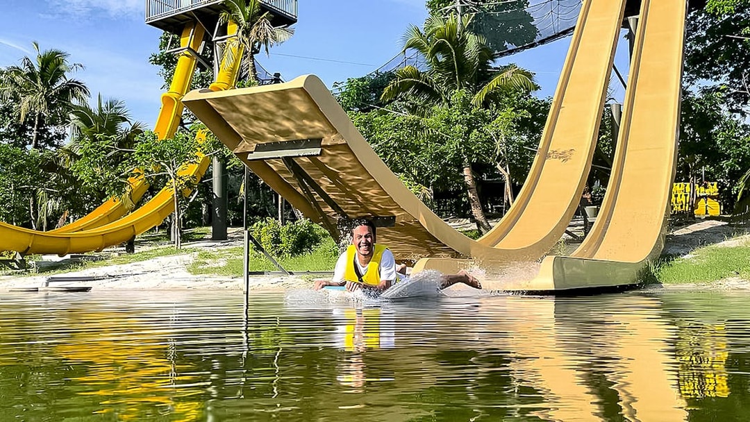 Man sliding down a water slide at ESCAPE Ipoh Theme Park, Malaysia.