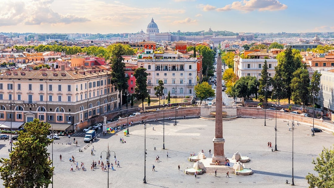 Egyptian Obelisk and fountains in Piazza del Popolo, Rome, with cityscape.