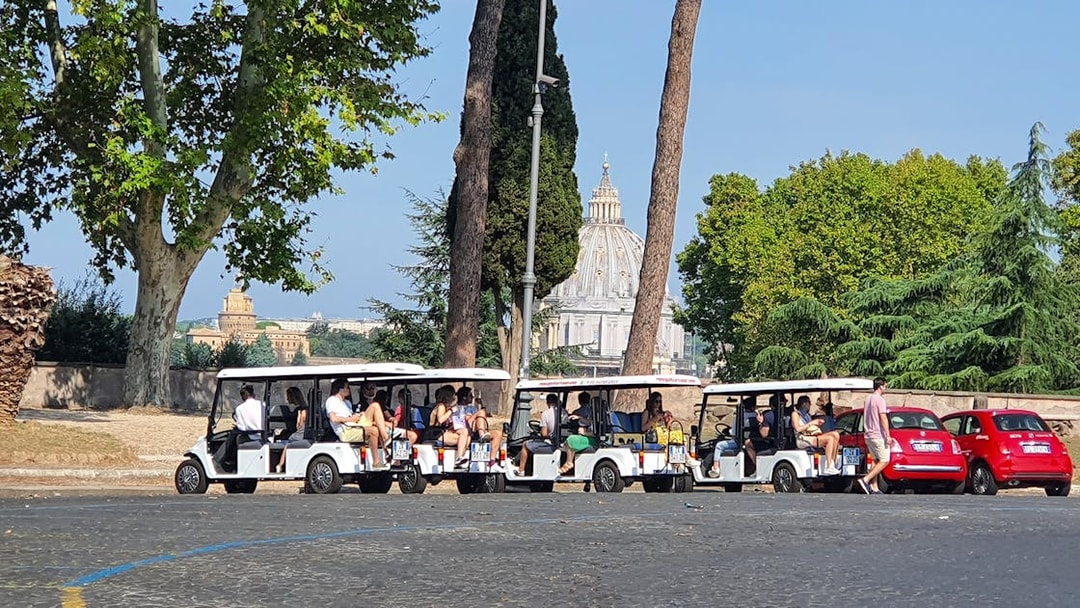 Tourists on golf carts near St. Peter's Basilica, Rome.