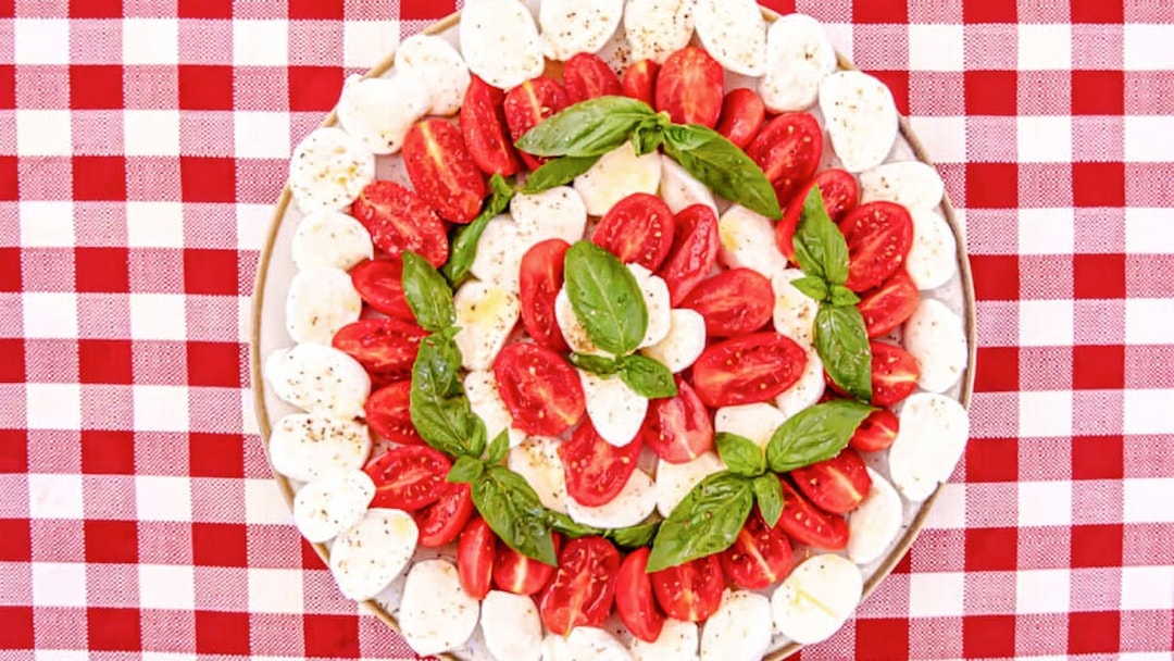 Caprese salad with tomatoes, mozzarella, and basil on a plate, Rome food tour.