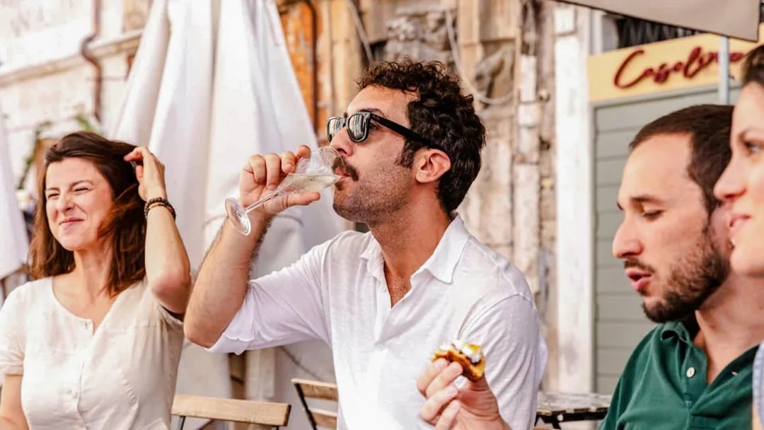 Group enjoying wine tasting on a Rome food tour.