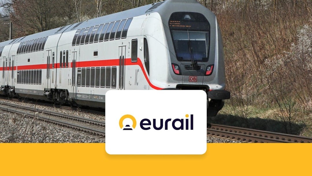 Eurail train traveling through Germany with Eurail logo in foreground.