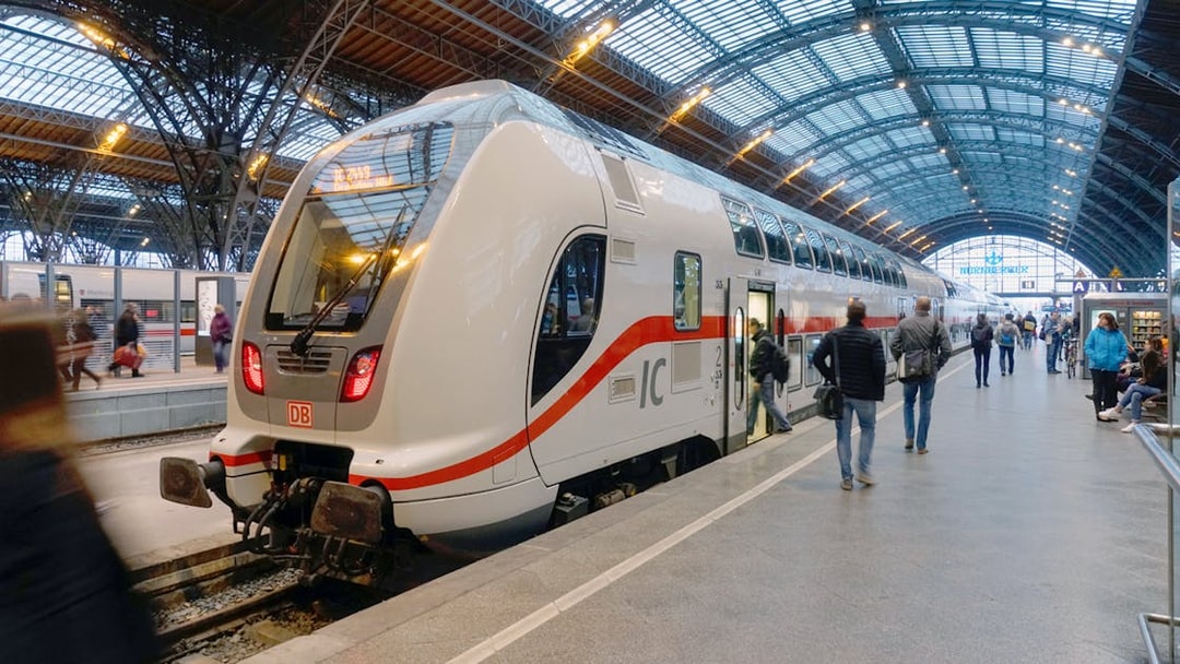 Euro Rail train at a German station platform with passengers boarding.