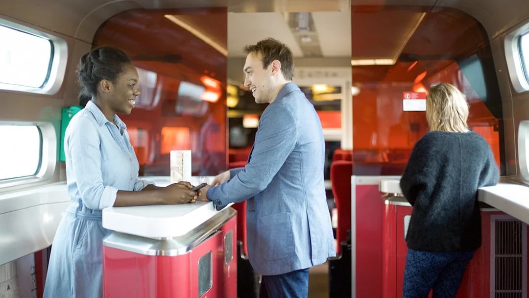 Euro Rail passengers at onboard cafe counter.