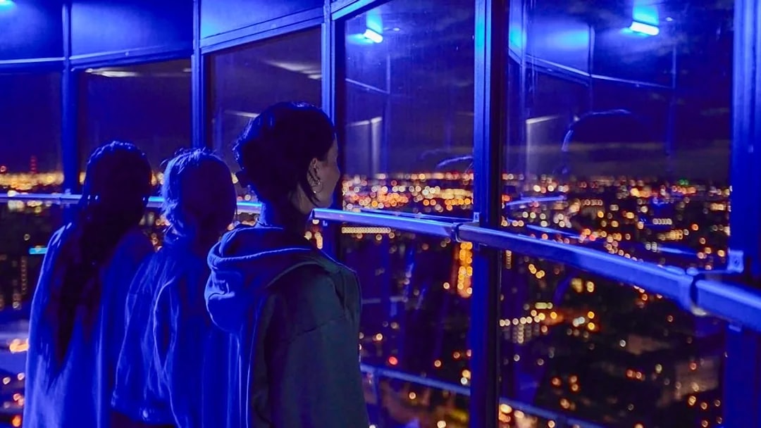 Guests enjoying the night view from Euromast viewing area in Rotterdam.