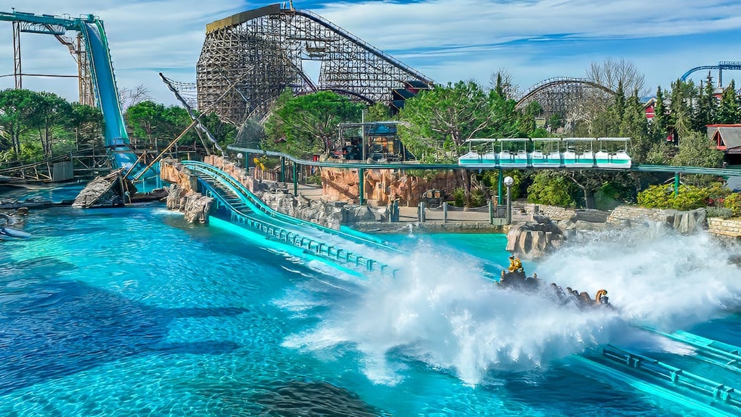 Blue Fire coaster loop with scenic backdrop and water splash at Europa-Park.