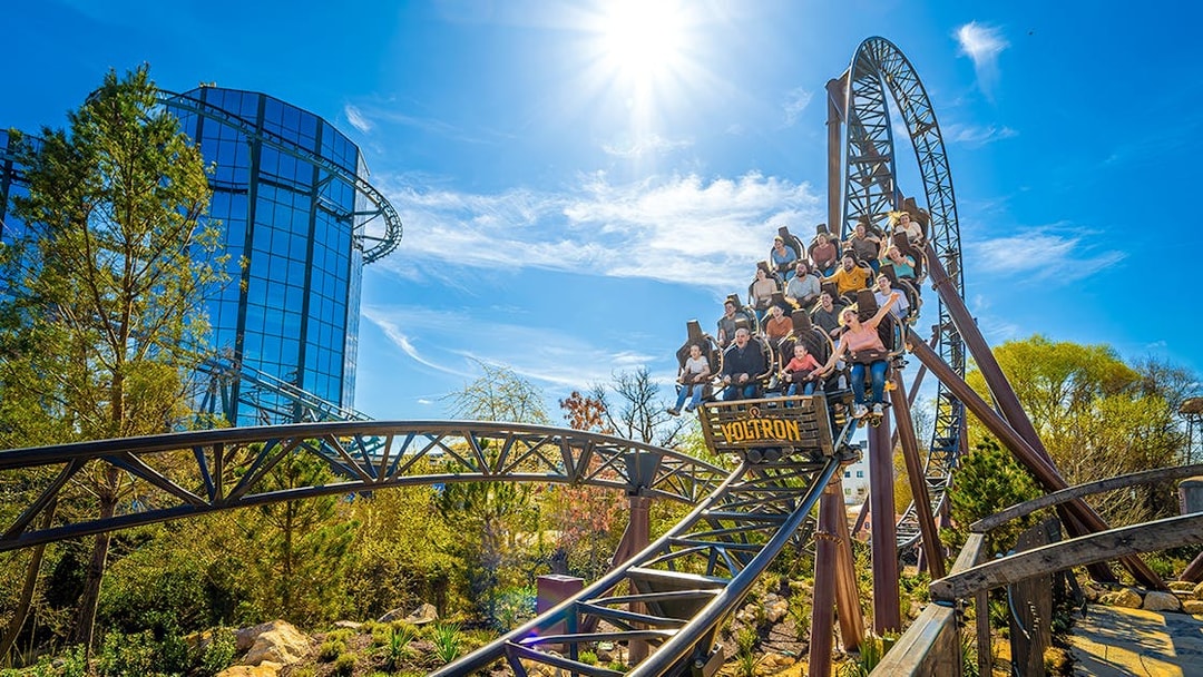 Rollercoaster riders on the Voltron Nevera in Croatia-themed area under a sunny sky.