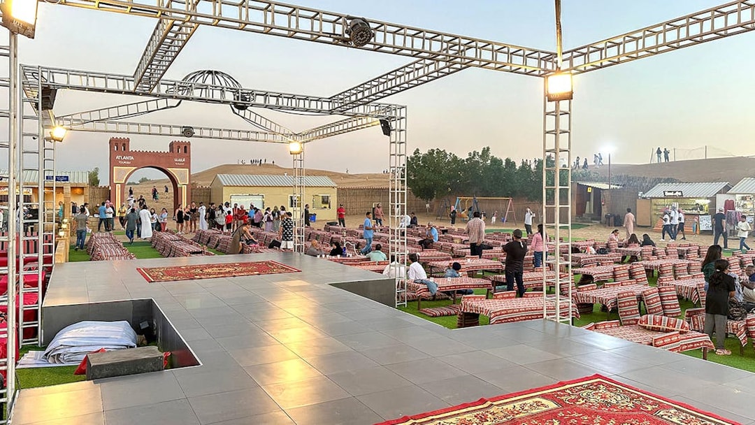 Evening desert safari setup with seating and stage in Dubai.
