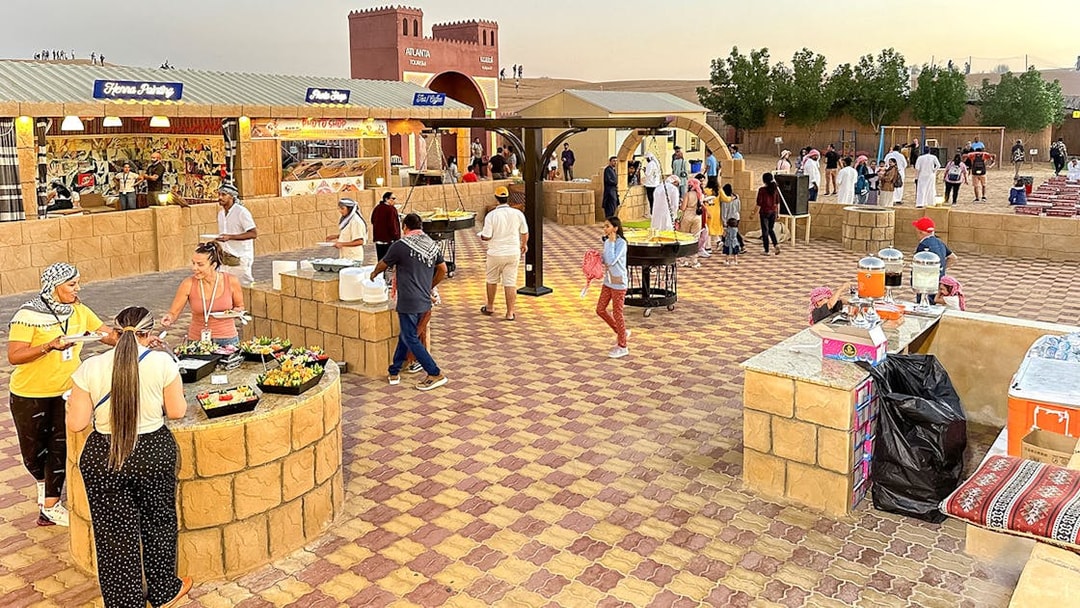 Buffet dinner setup with diverse food options at Dubai desert safari.