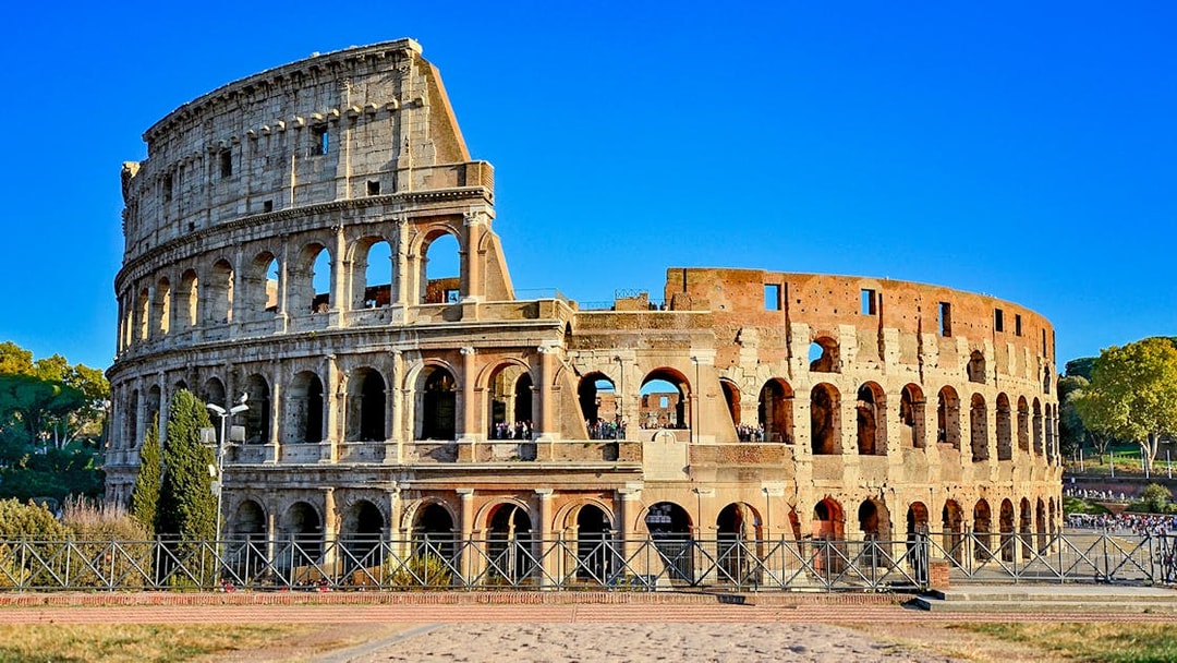 Colosseum in Rome, Italy under a clear blue sky.