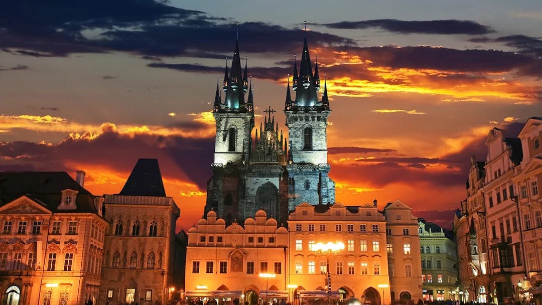 Tyn Church at sunset in Prague's Old Town Square.