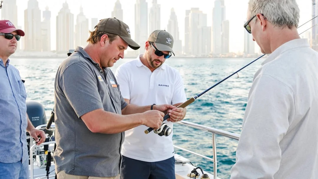 Men preparing fishing rods on a sports fishing cruise in Dubai.