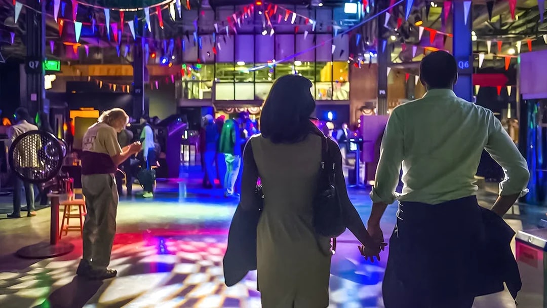 Couple exploring interactive exhibits at the Exploratorium in San Francisco.